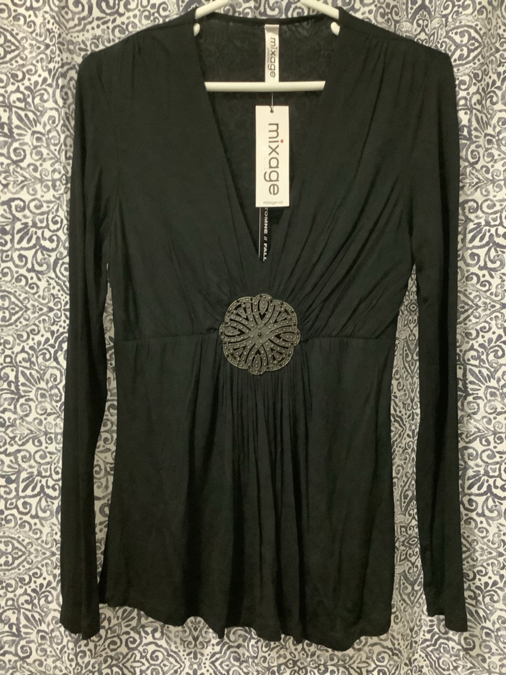 Mixage Black Long Sleeve V-Neck Top with Decorative Medallion